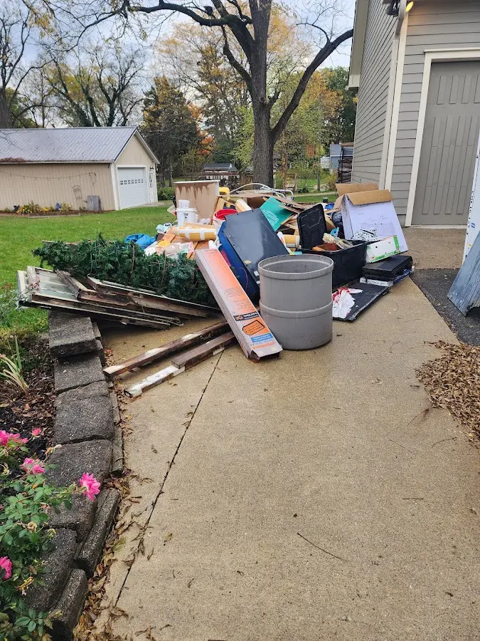 Dumpster being loaded with debris for Estate Cleanout Dumpster Rental in Swissvale